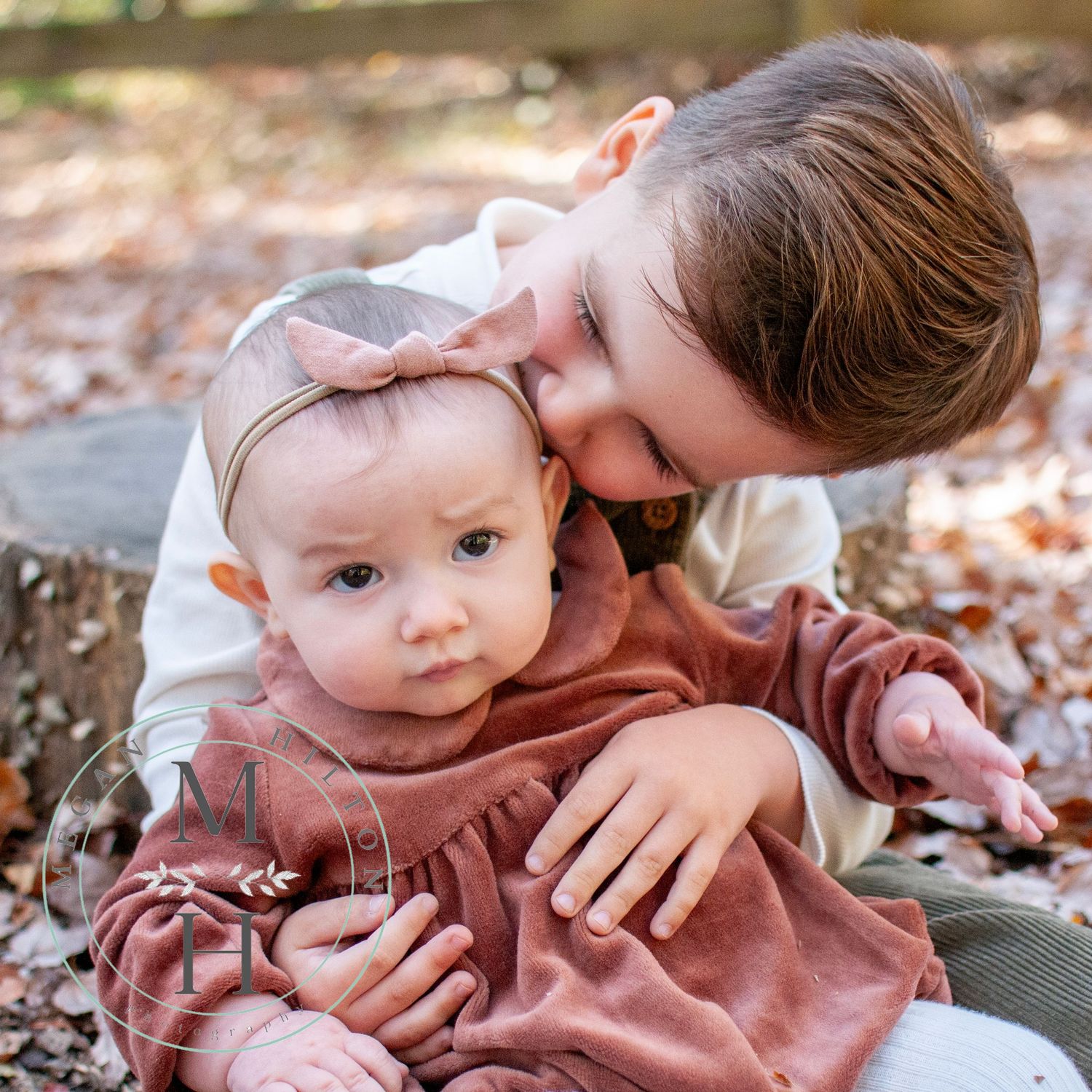 Sibling close up picture kissing infant