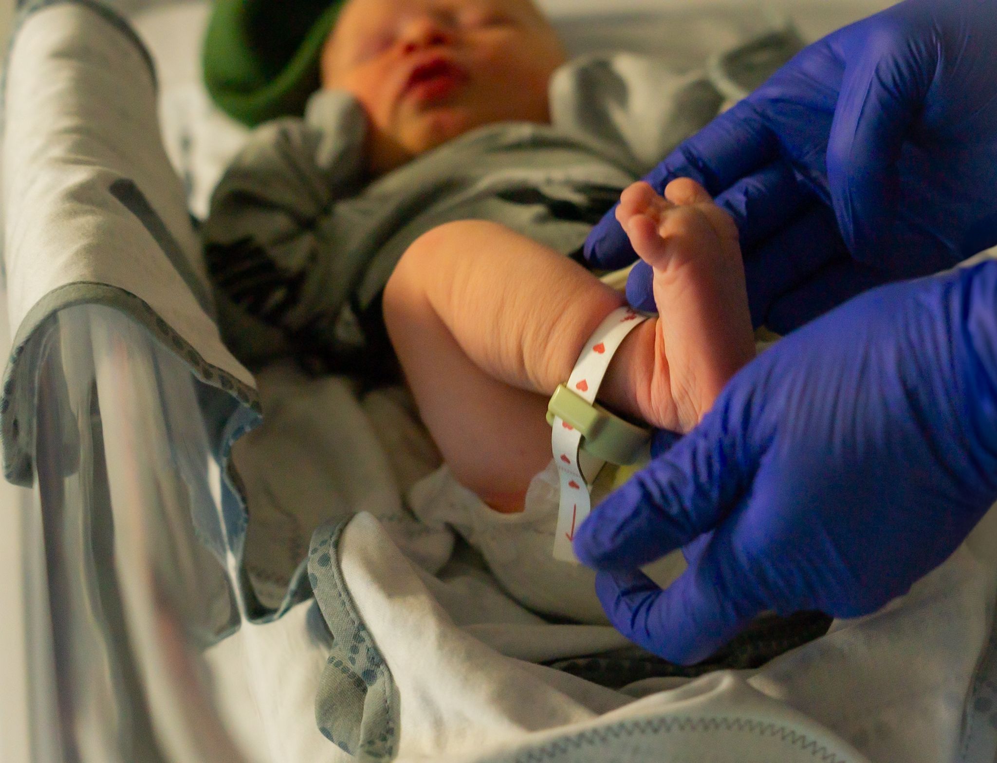 Close up view of medical examination of newborn baby's hands.