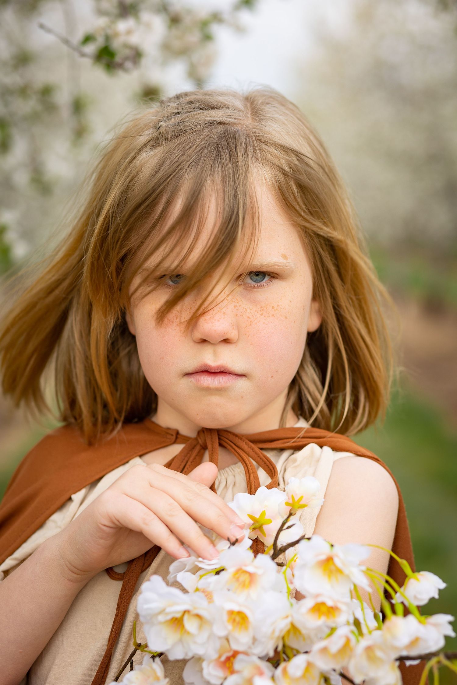 serious girl with apple blossoms utah Rowley's Red Barn