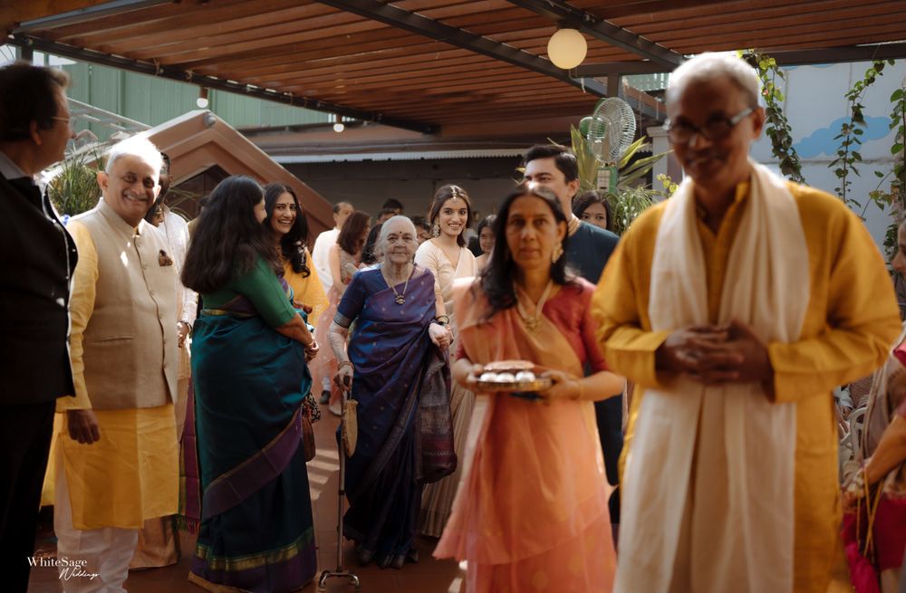 A group of guests in traditional Indian attire gathered at a celebration.