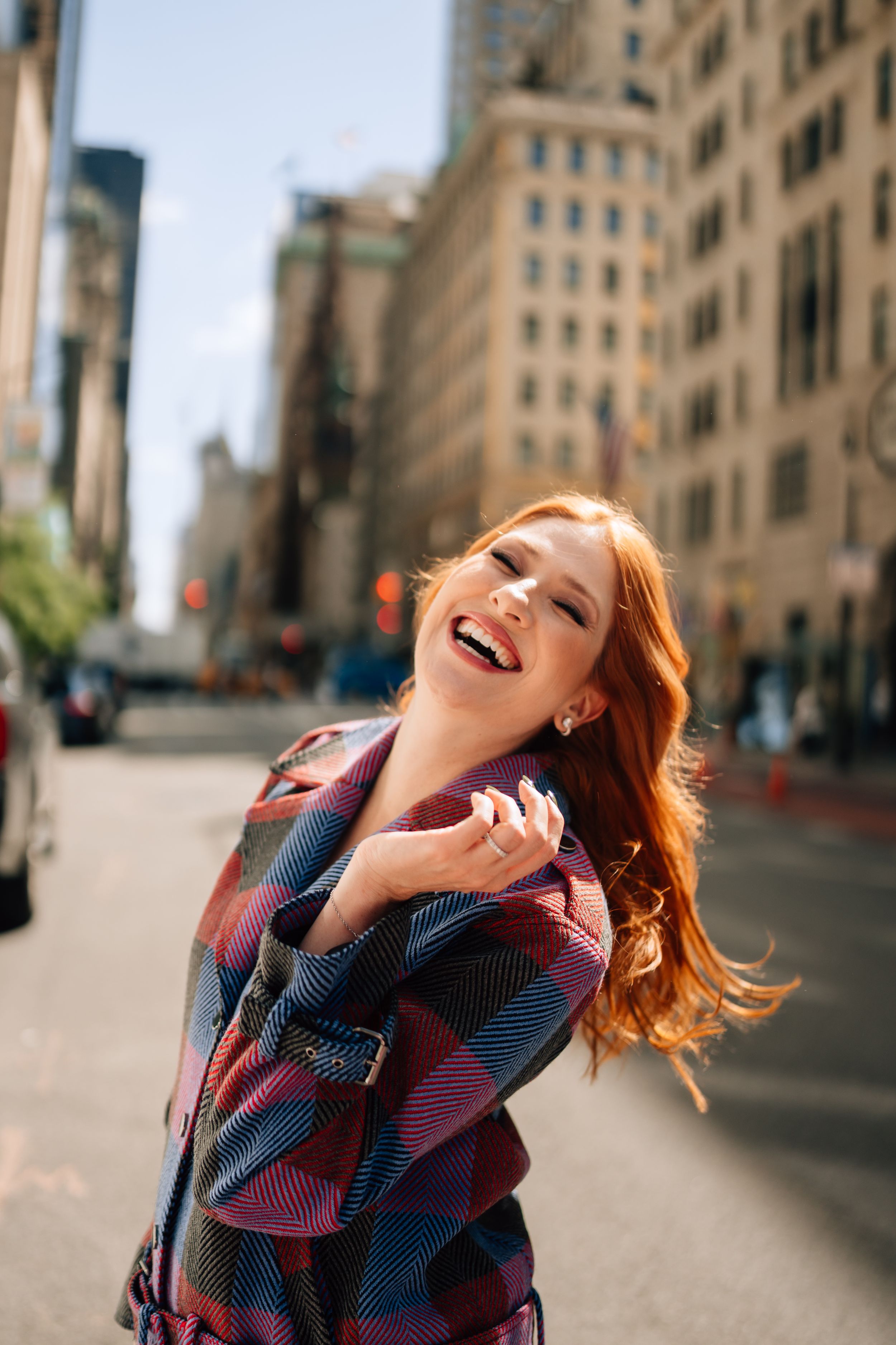 A joyful moment captured on a city street with urban buildings in the background.