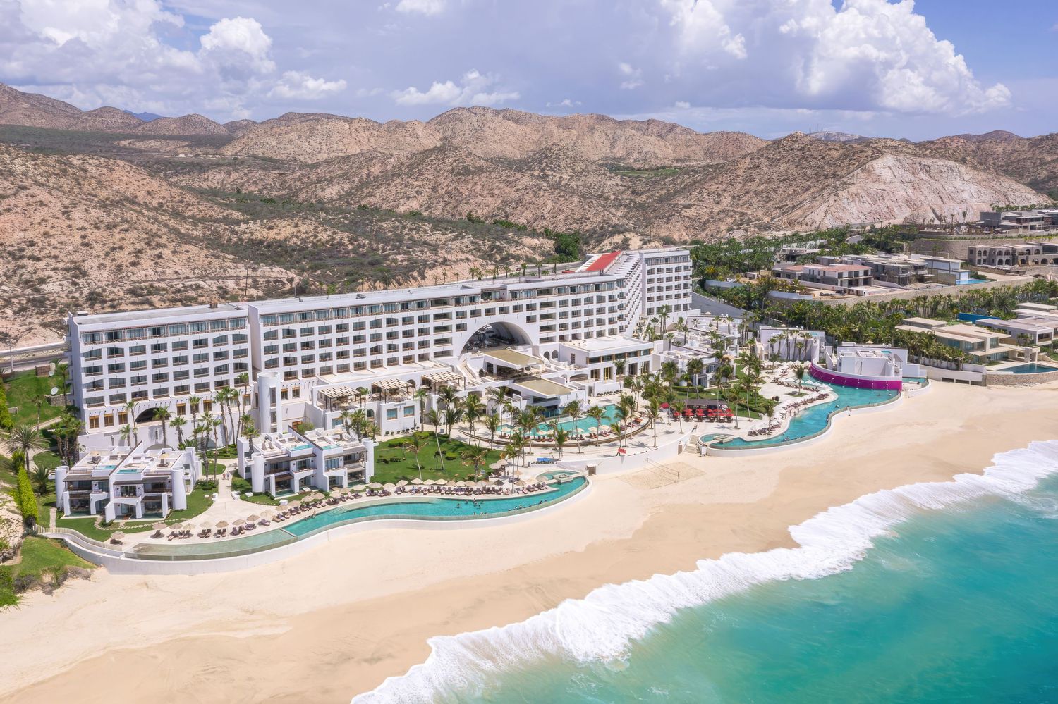 Luxury aerial view at Marquis Los Cabos, beachfront resort with multiple swimming pools and pristine white sand beach.