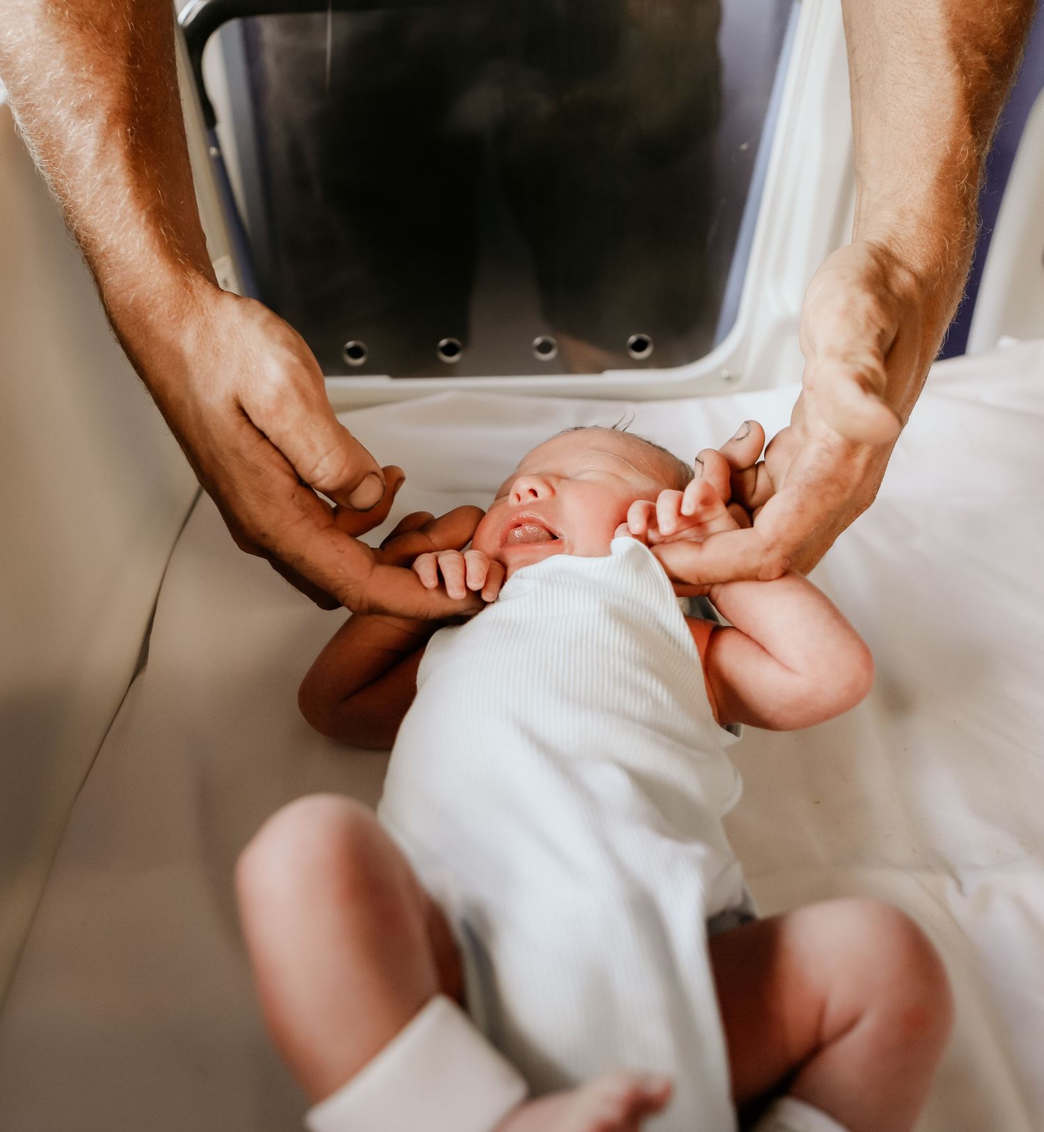 Hospital Newborn Photography. Dad holding hands