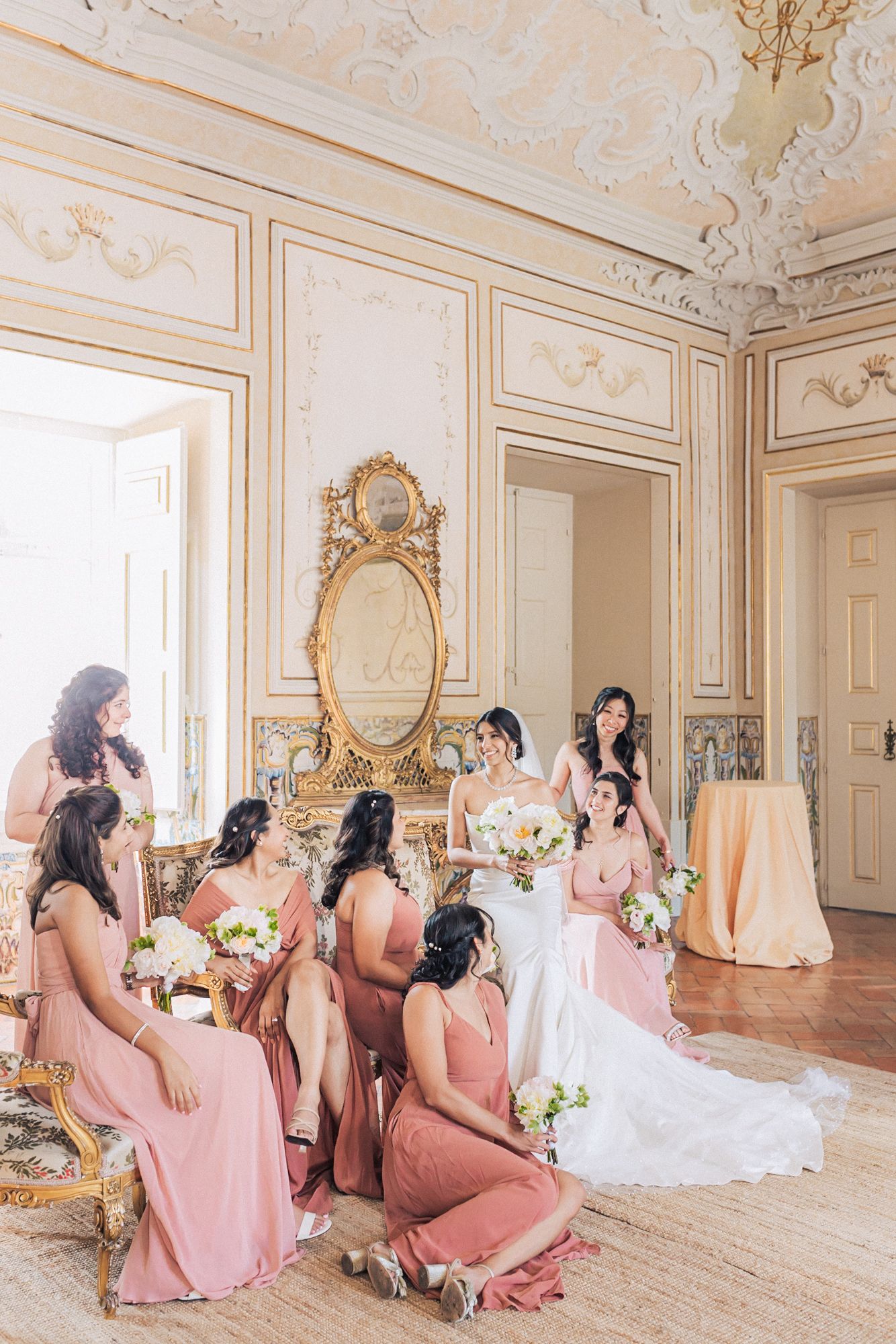 Bridesmaids in pink dresses posing, photographed by an Indian destination wedding photographer in Portugal – Correio Mor Palace
