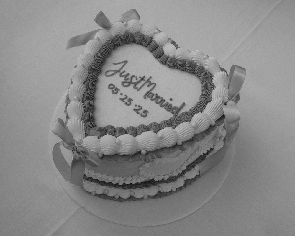Series of heart-shaped wedding cakes decorated with white frosting and delicate floral designs.
