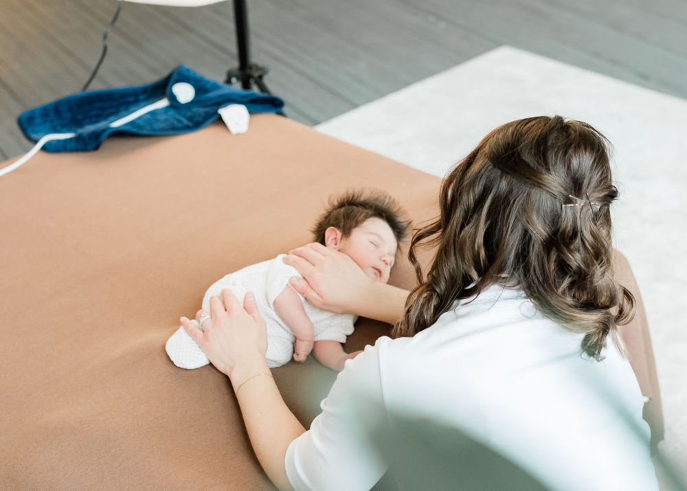 calming a newborn baby during a photo session