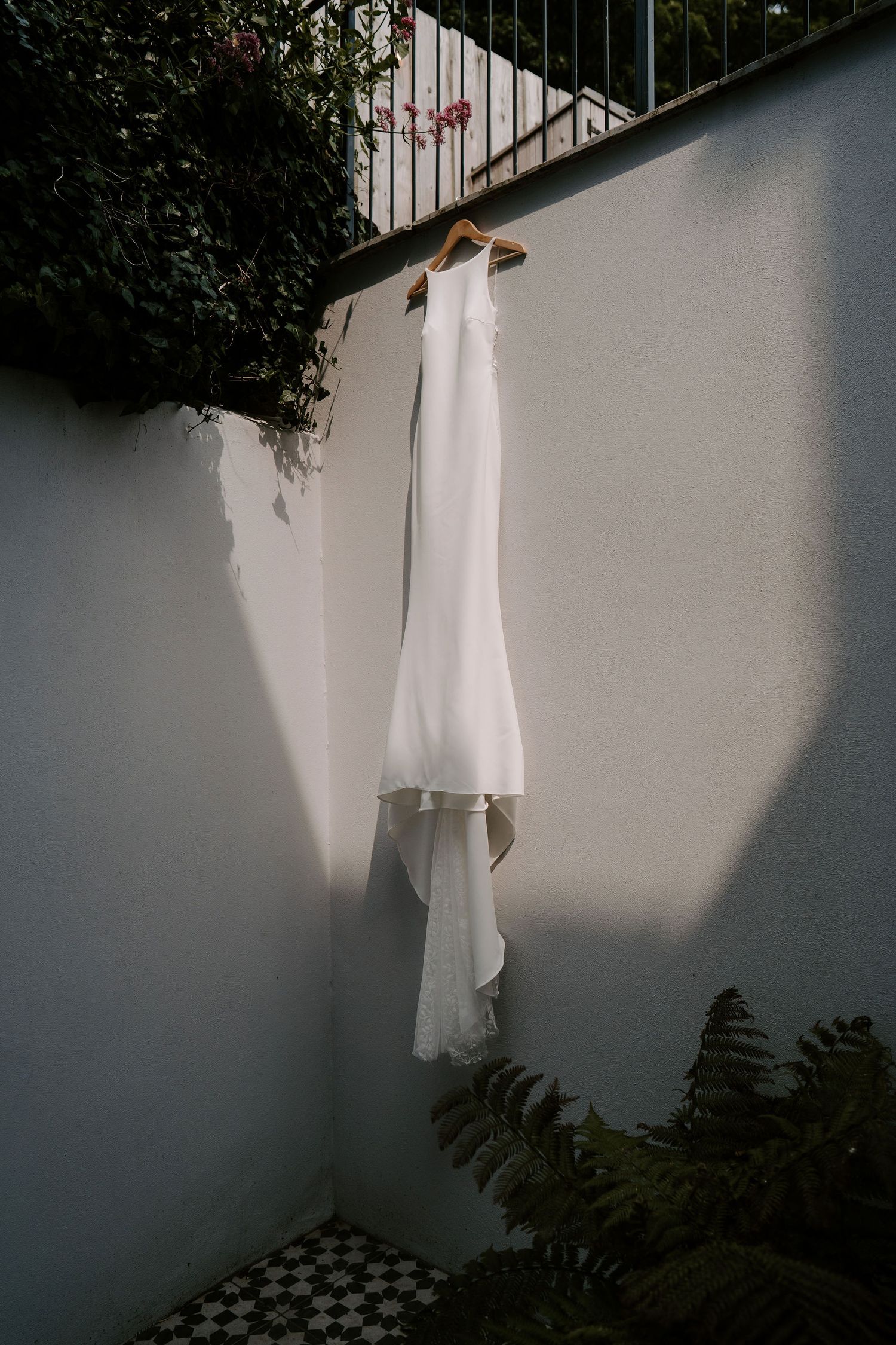 Tunnels Beach wedding venue in north Devon, brides wedding dress hanging up in the sunshine