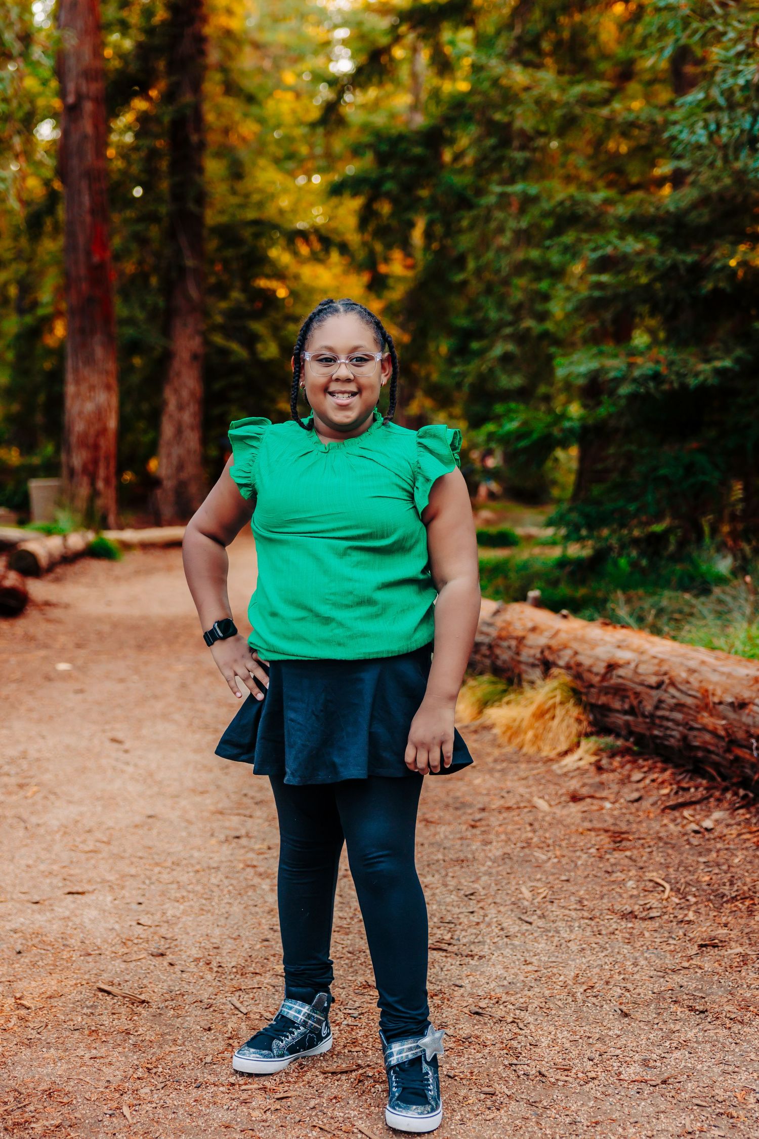 Three cropped photos show a person in a bright green shirt and dark pants on a dirt path in an autumn forest setting.