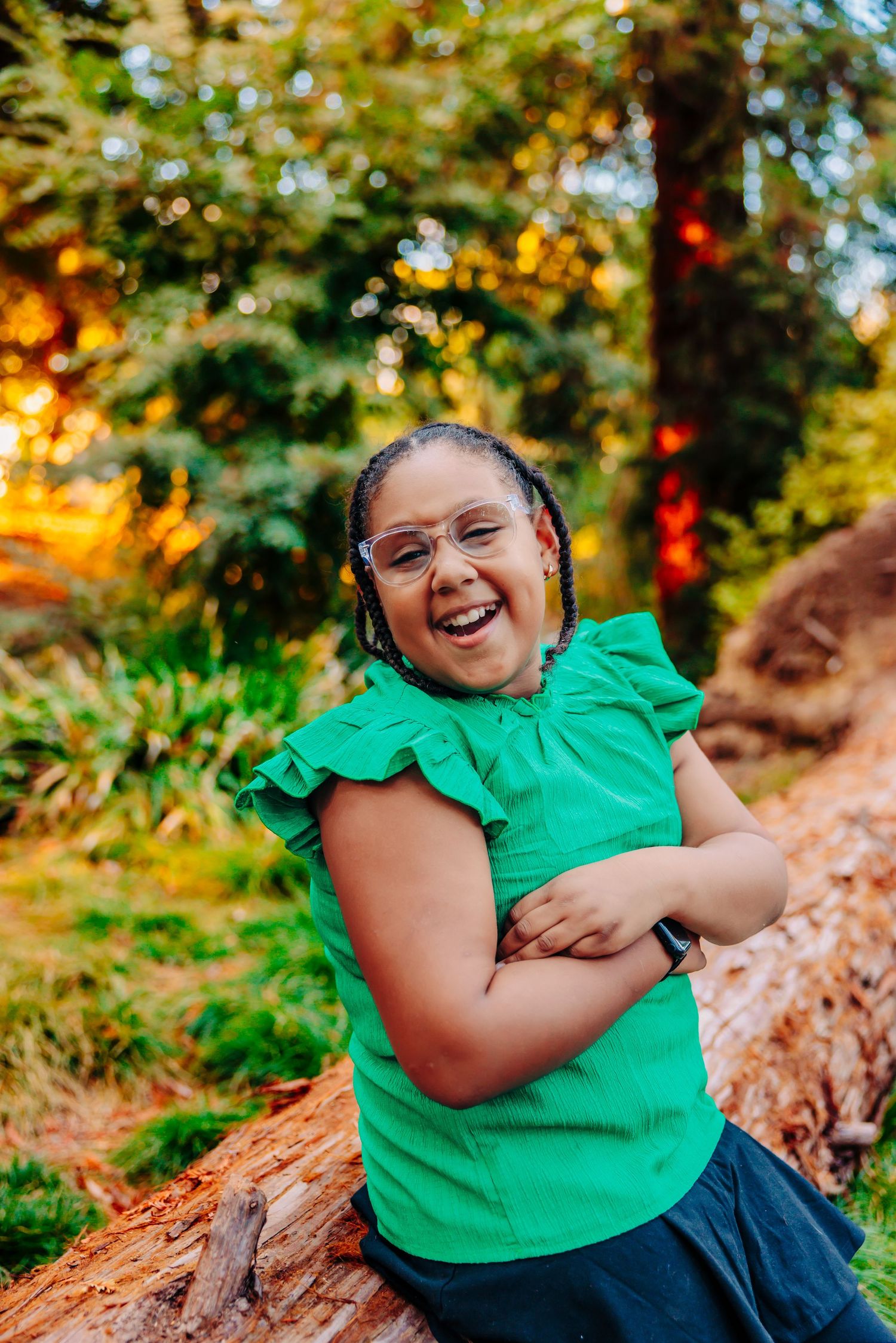 Joyful moment captured in a green top against autumn foliage background during golden hour in nature.