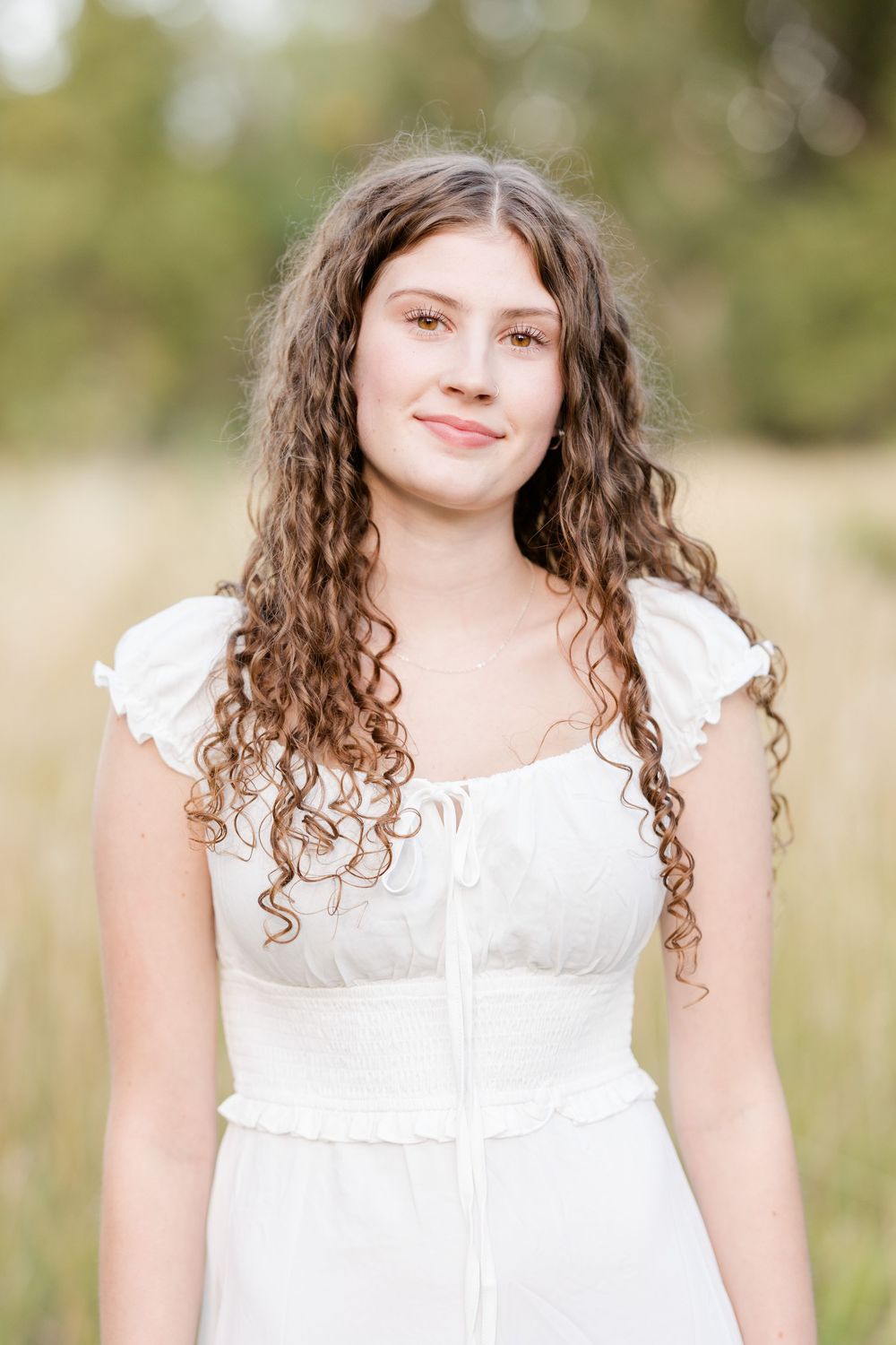 A series of similar portrait photographs showing someone in a white dress outdoors with a natural blurred background.