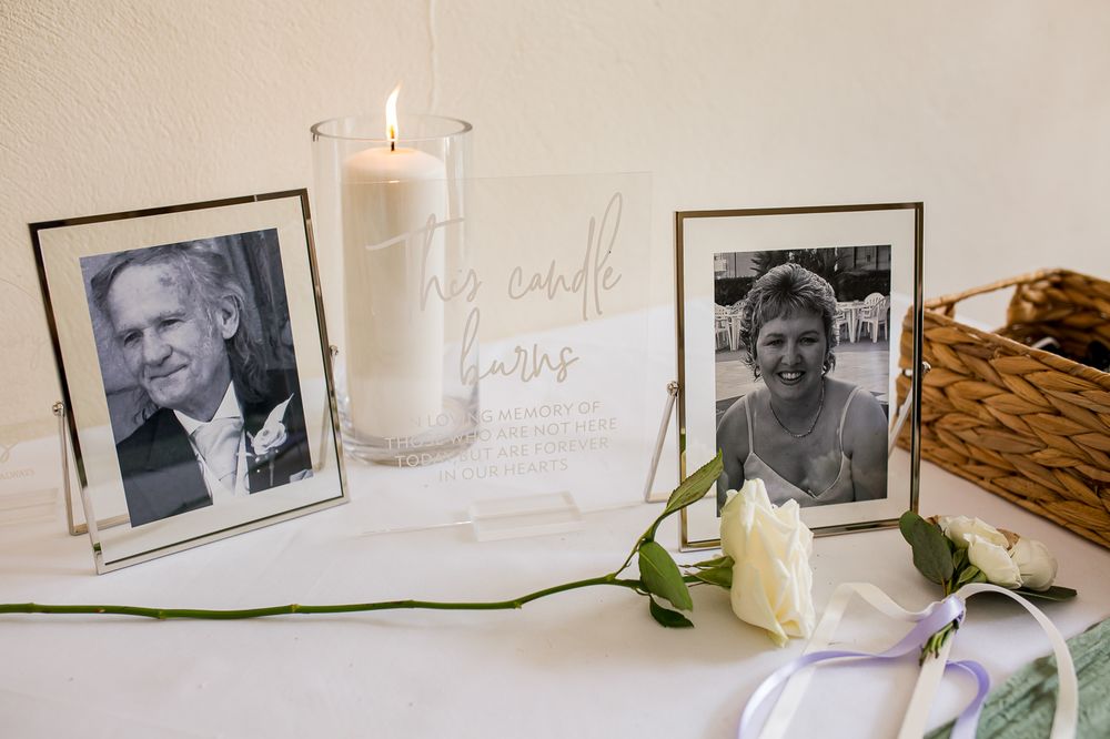 Memory table with vintage black and white photographs and white floral accents.