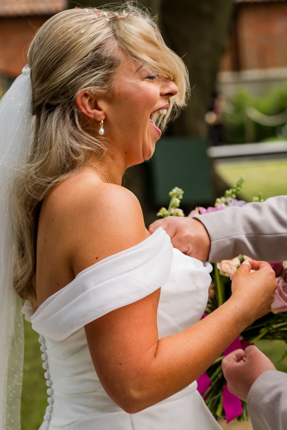 A white wedding dress detail shows an off-shoulder design against a garden background.