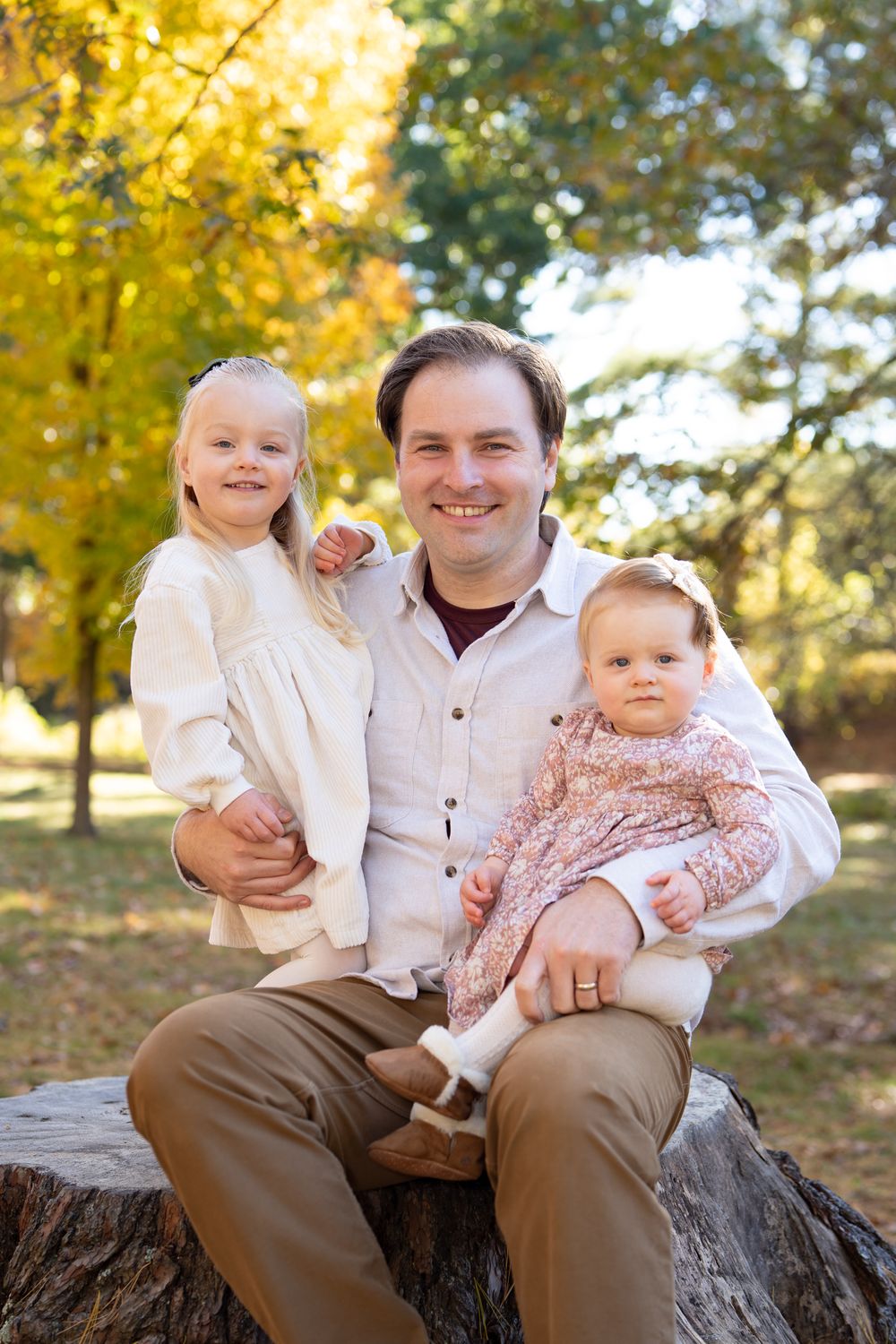 Father & daughters family portraits in New England Fall Foliage. Photography by Leah Ramuglia at the Wayside Inn Grist Mill in Sudbury, MA.