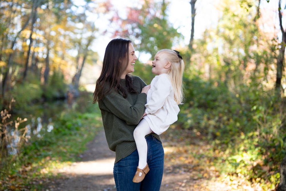 Mother & daughter family portraits in New England Fall Foliage. Photography by Leah Ramuglia at the Wayside Inn Grist Mill in Sudbury, MA.