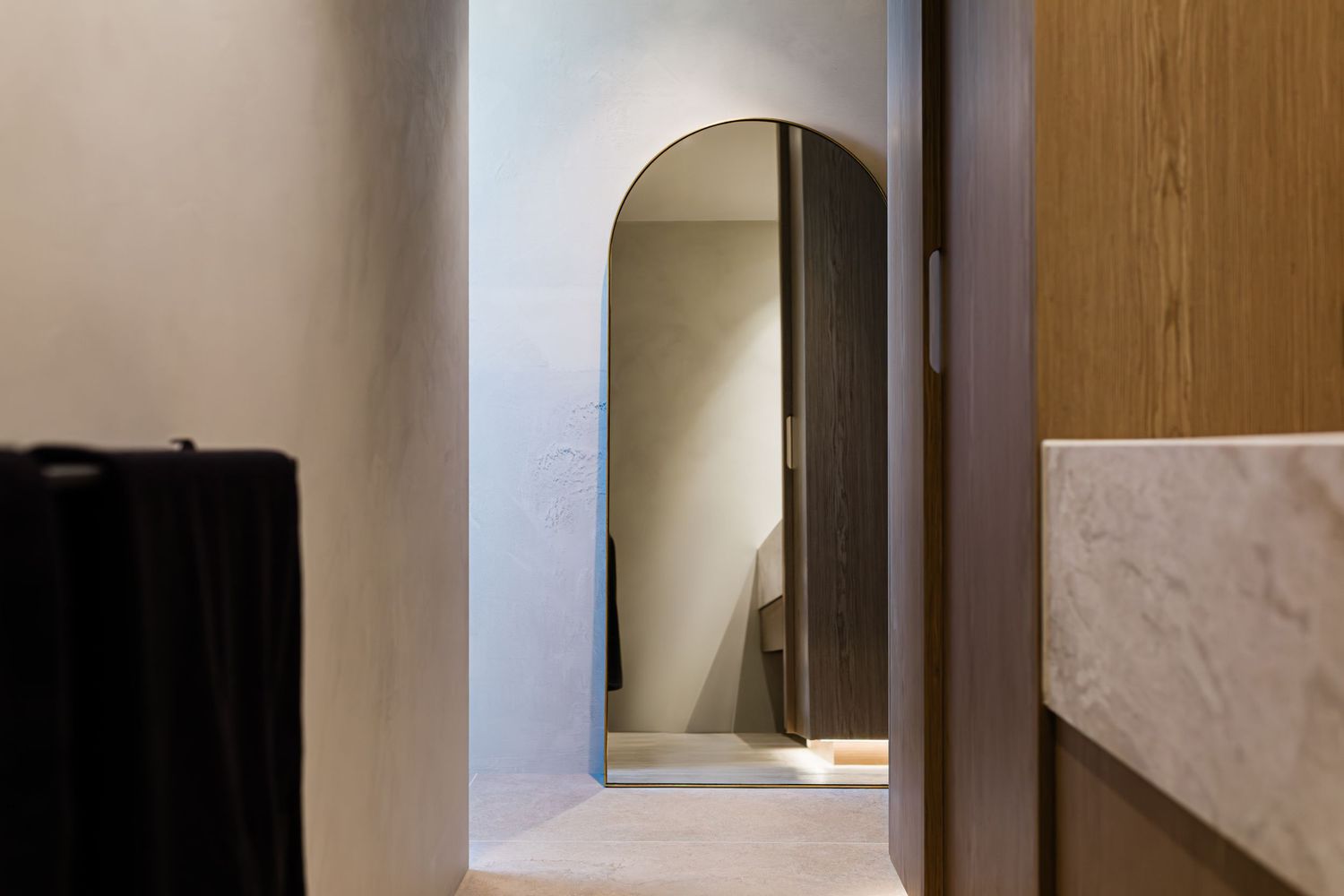 A sleek modern interior hallway features a minimalist design with wood paneling and soft lighting.