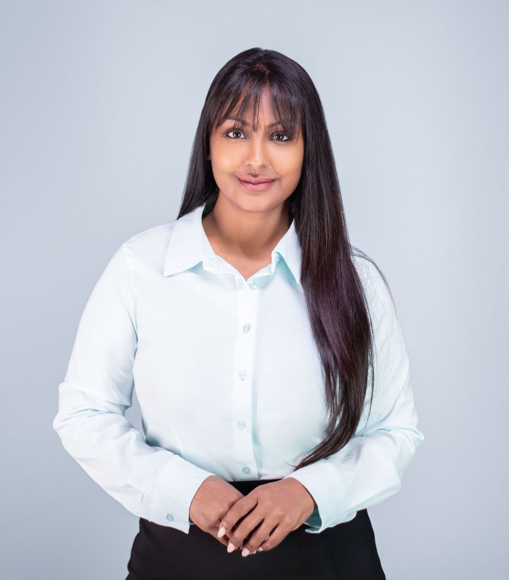 A person in a white button-down shirt poses against a light gray background in a series of professional headshots.