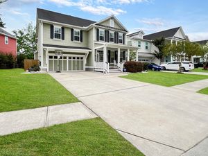 Aerial view of a residential neighborhood with concrete driveways and well-maintained lawns.