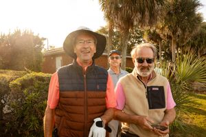 Group enjoying a sunny day at a golf tournament fundraising event.