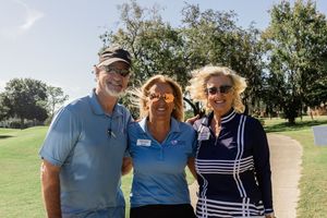 Group of players socializing and gathering near golf carts on a beautiful day at the golf course.