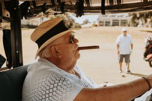 Golfers relaxing in shaded golf carts between rounds on a sunny afternoon.