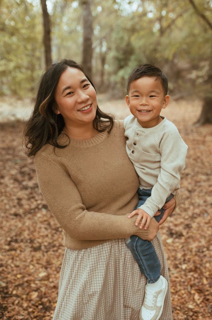 A heartwarming moment between parent and child enjoying time outdoors in autumn.