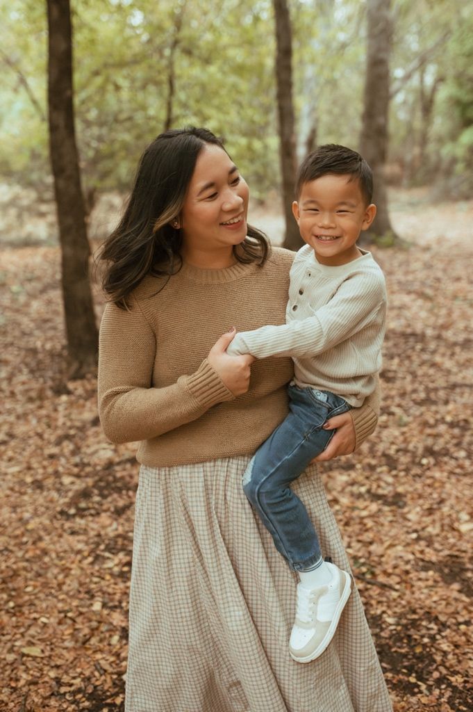 Candid family photos showing playful interaction among loved ones in an autumn forest setting.
