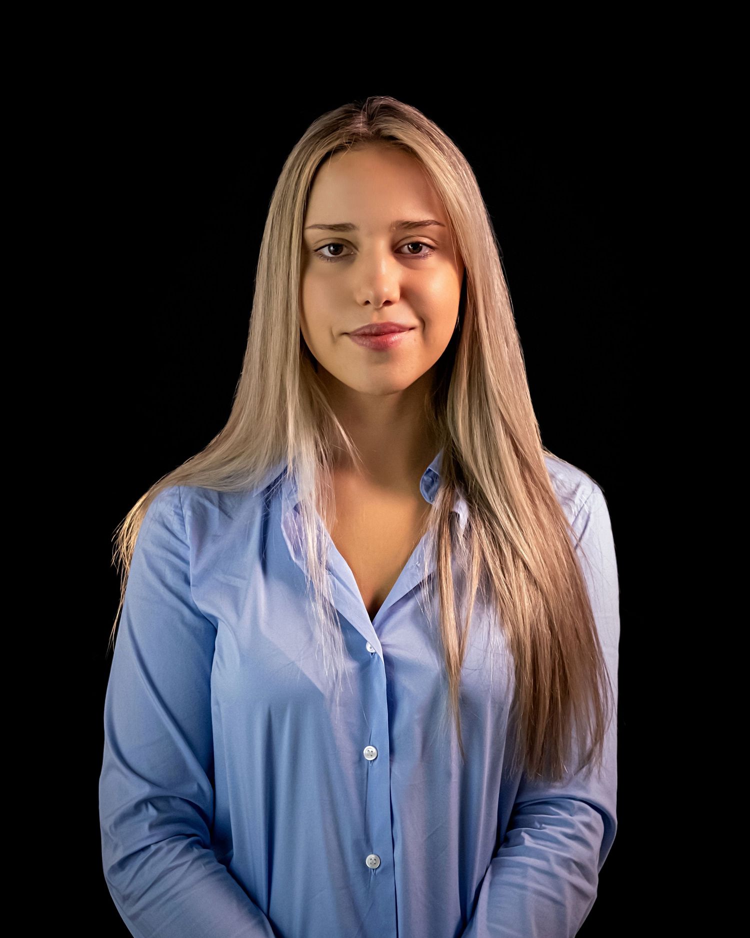 Portrait series showing a person in a light blue button-down shirt against a black background.