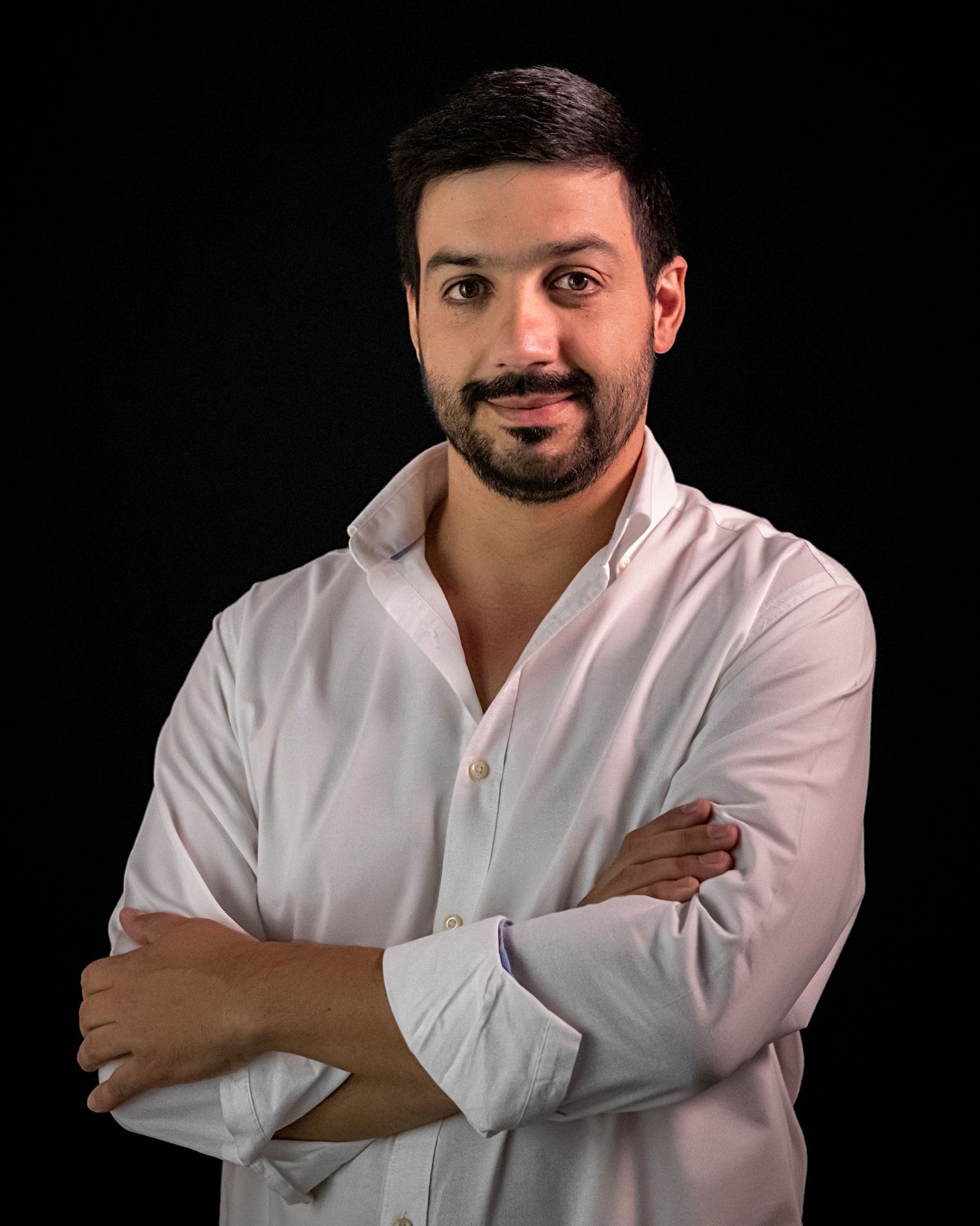 Portrait sequence of a bearded person in white shirt against black background.