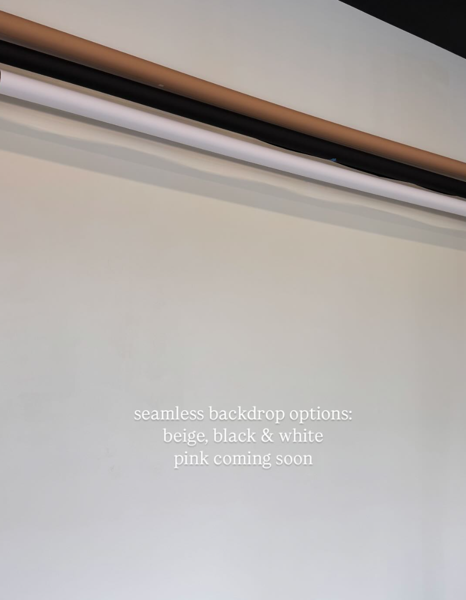 A series of seamless gray gradient backdrops displayed in a horizontal row against a white wall.