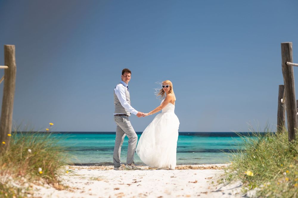 Romantic beach photoshoot with crystal clear turquoise waters in the background.