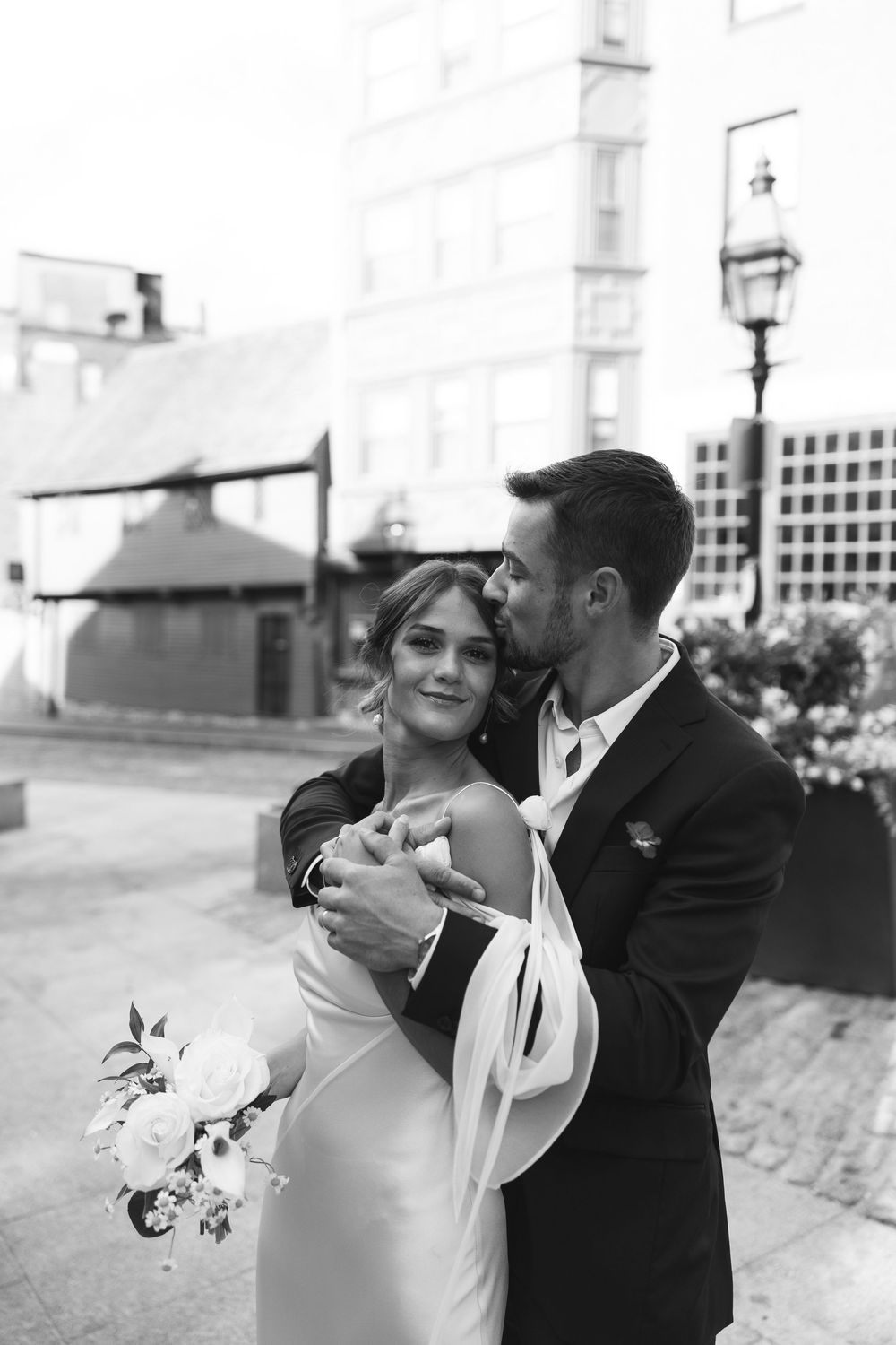 Romantic black and white wedding photos showing intimate moments on a rooftop venue.