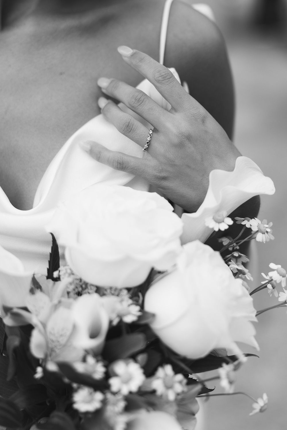 Black and white detail shots of wedding flowers and dress fabric.