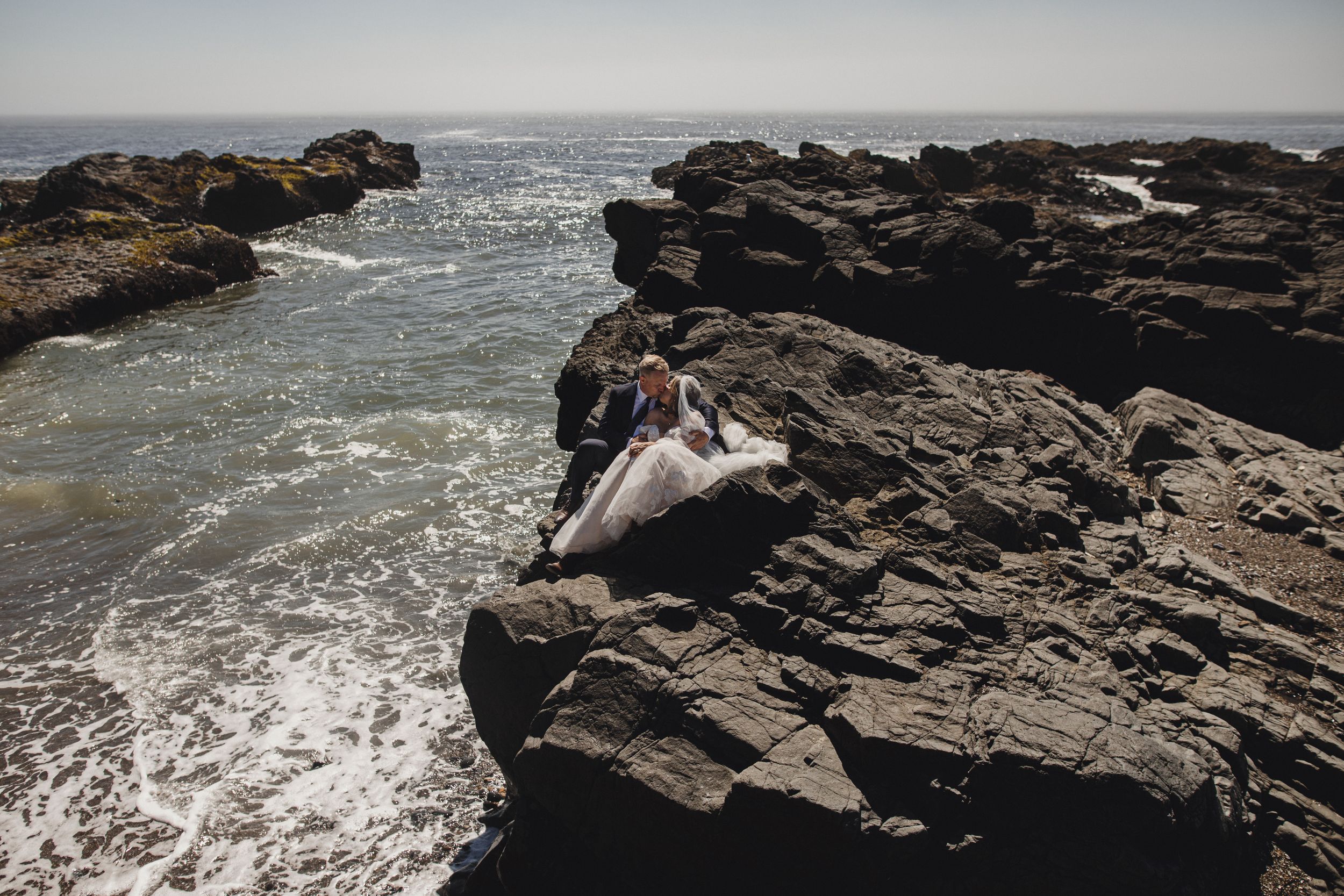 Rocky coastal cliffs meet the crashing waves of the ocean on a dramatic shoreline.
