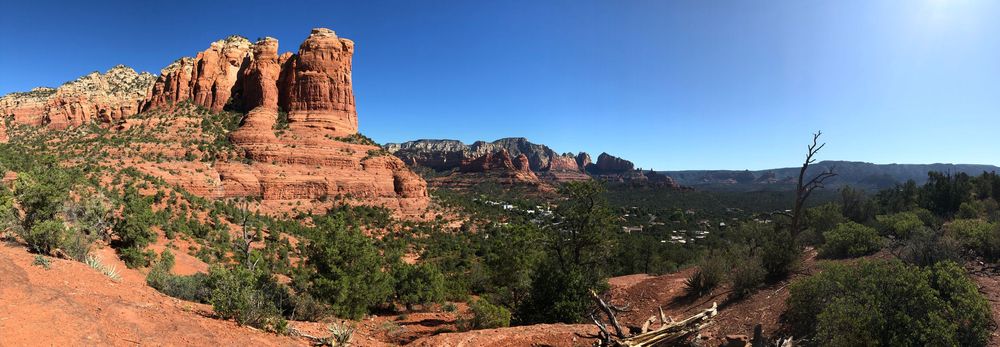 Wide panoramic vista of red rock buttes and desert terrain stretching across the horizon in Arizona.