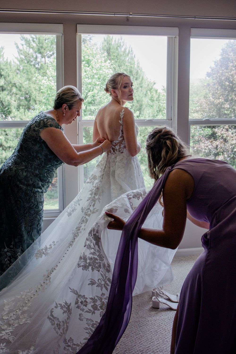 A series of photos showing bridesmaids in purple dresses helping adjust a white wedding gown during preparation.