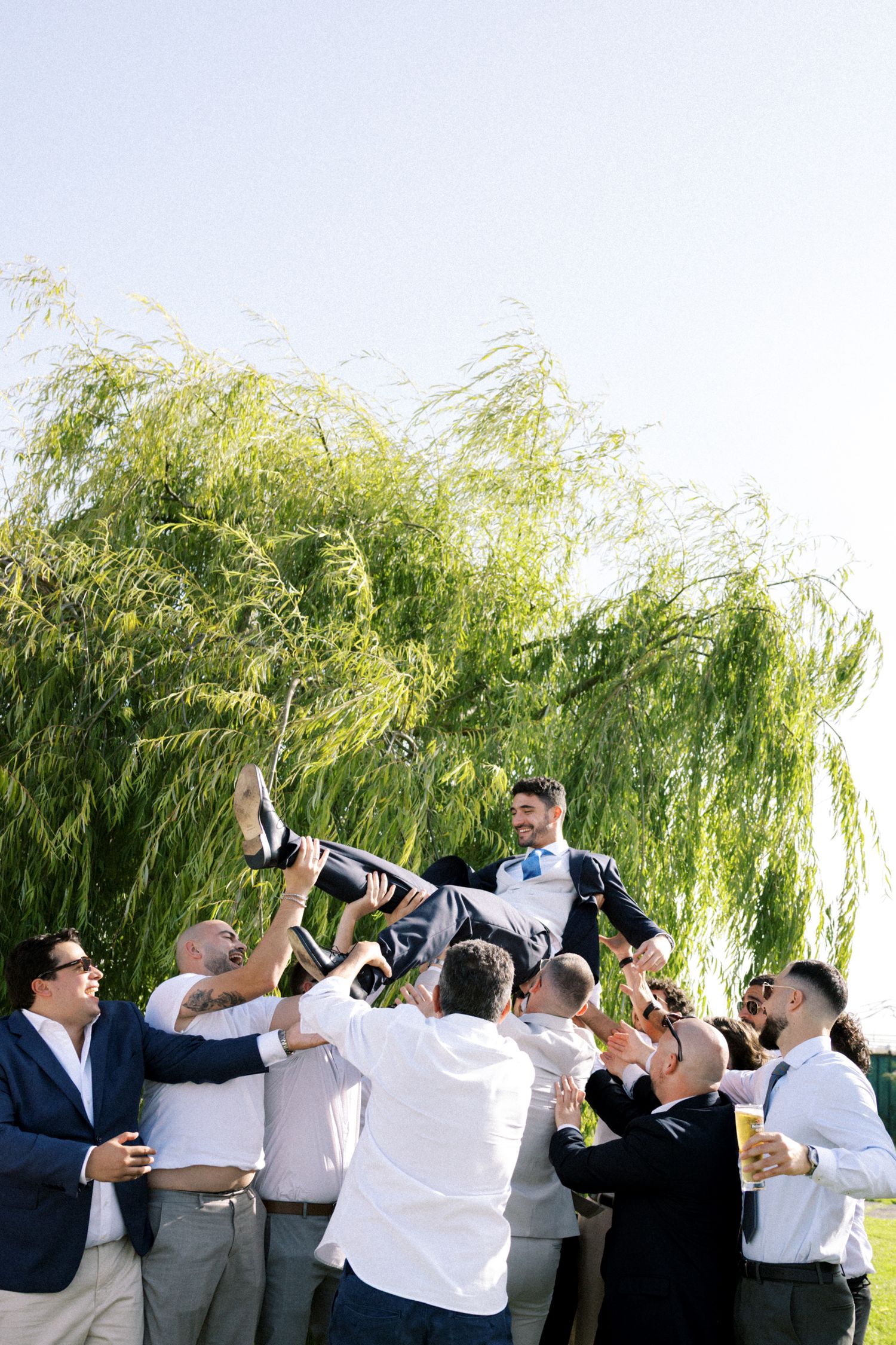 Groom lifted by friends during wedding celebration in Portugal