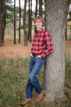 A series of three photos showing someone in a red plaid shirt and jeans posing playfully against a tree in a wooded setting.