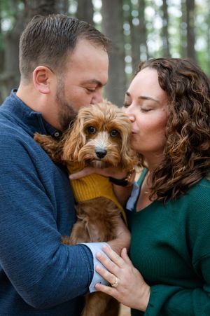 Couple shares intimate moments with their brown dog in a series of close-up forest portraits.