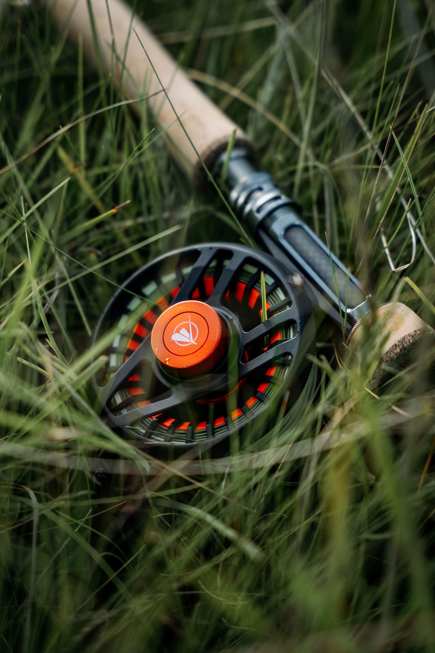 Close-up shots of fishing reels being assembled and maintained in a workshop setting.
