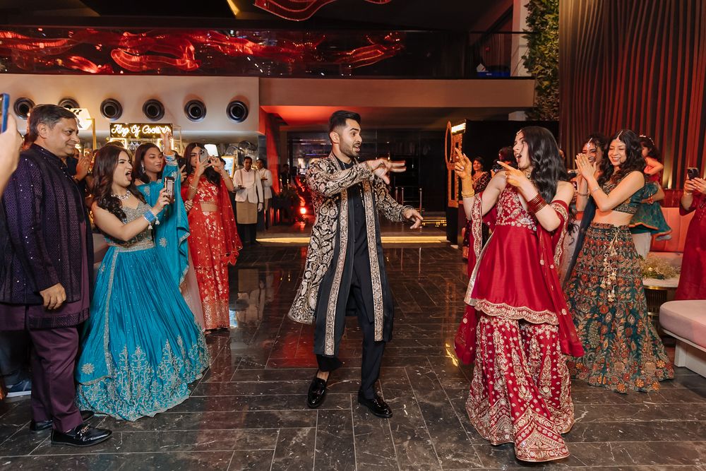 Shorye and Leah at their high-energy Indian wedding Sangeet celebration at Tivoli Chattarpur