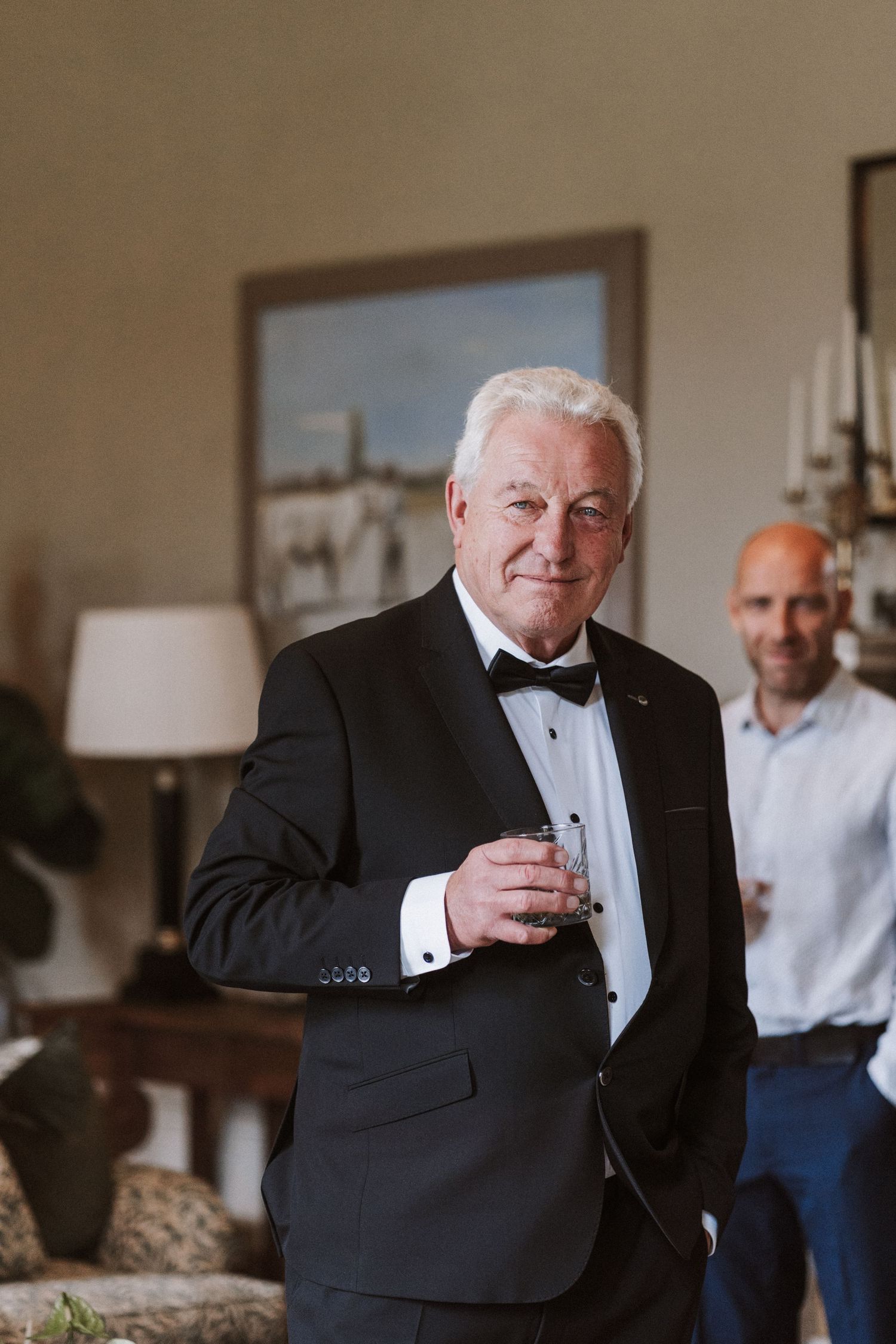 A person in a black tuxedo sips from a glass in a series of candid photos.