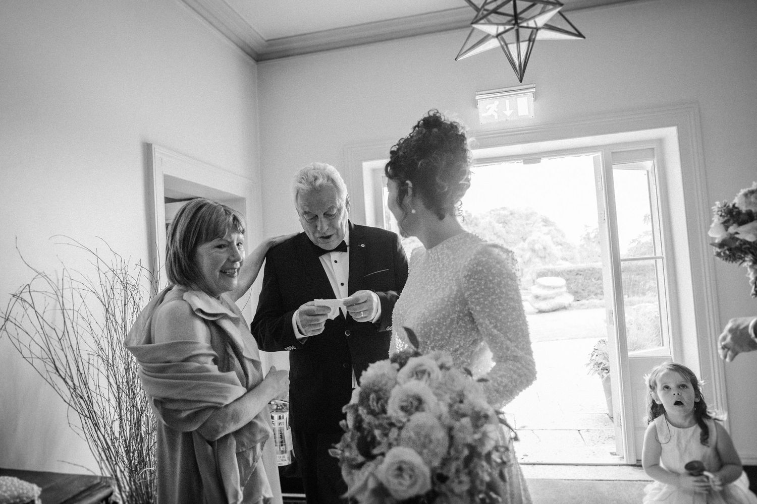 A black and white photo collage showing intimate moments from a wedding celebration.