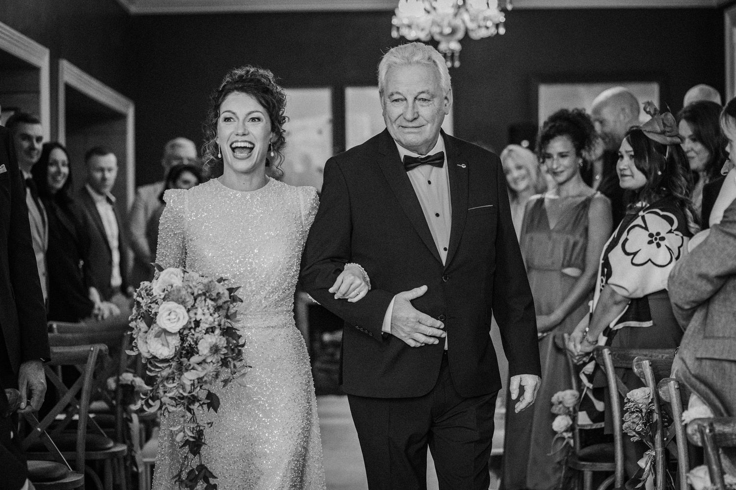 Black and white wedding photos showing elegant moments during a ceremony and reception.