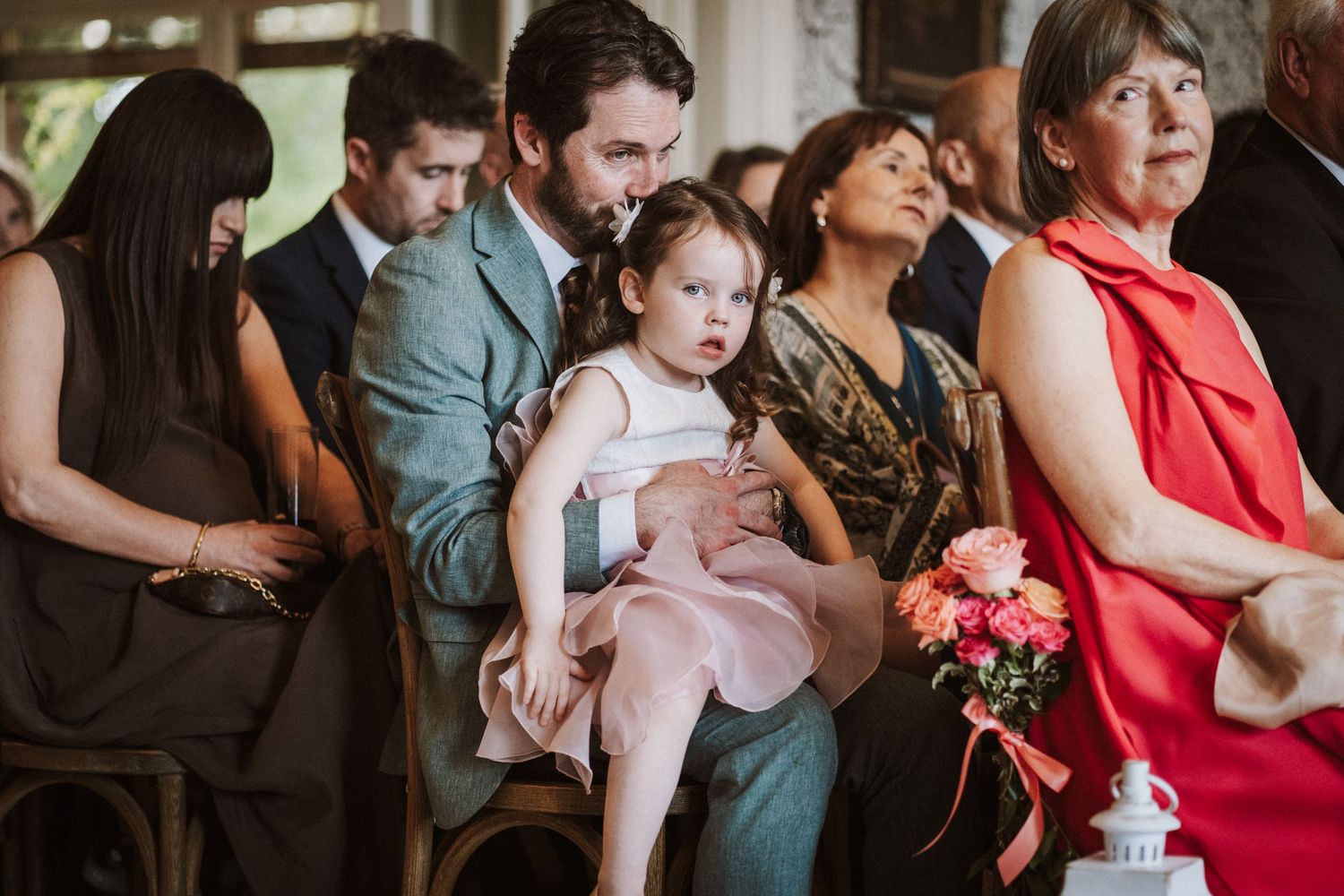 A group of people in formal attire dance and celebrate at an elegant wedding reception.