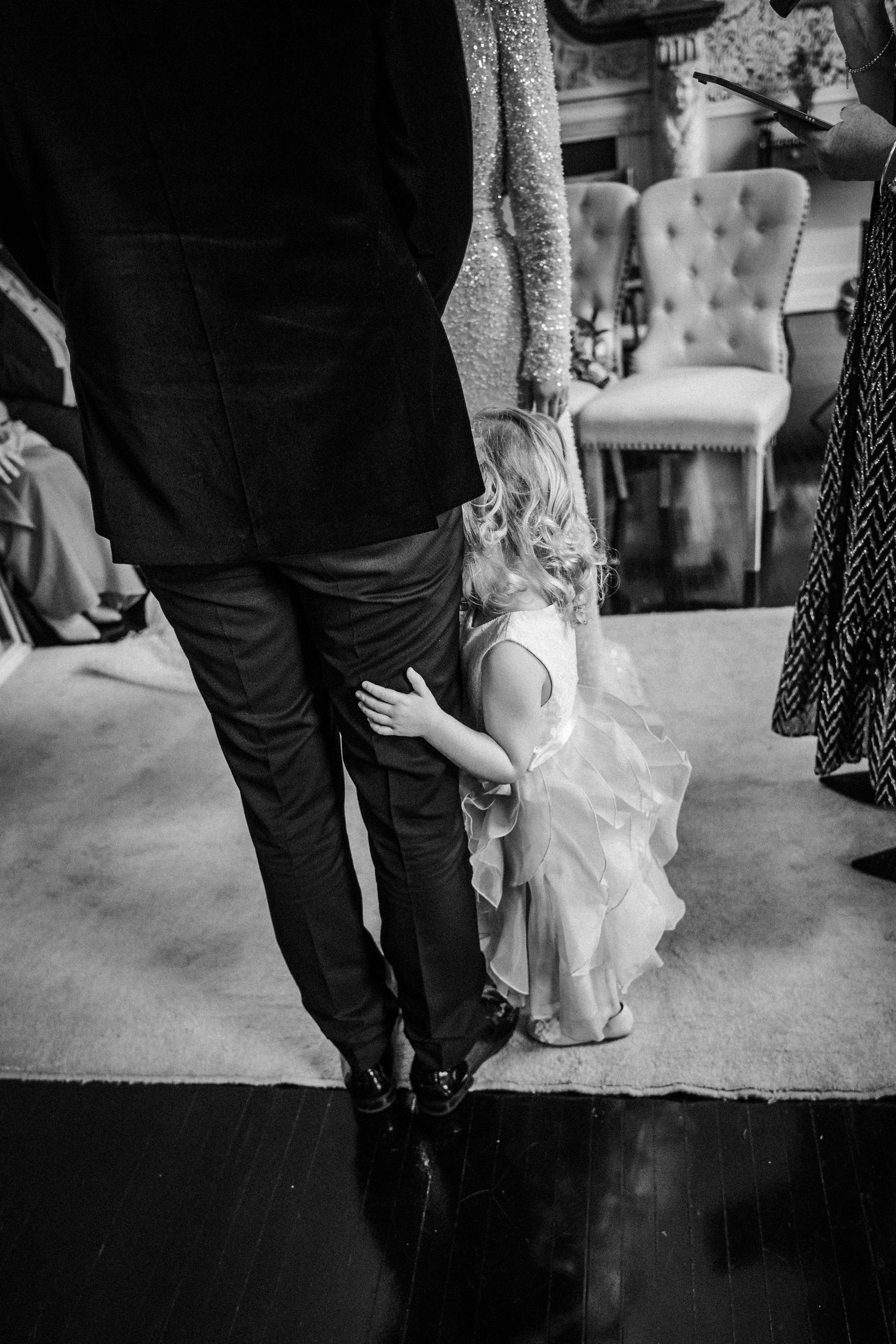Black and white wedding reception photo showing guests dancing and mingling on a dance floor.