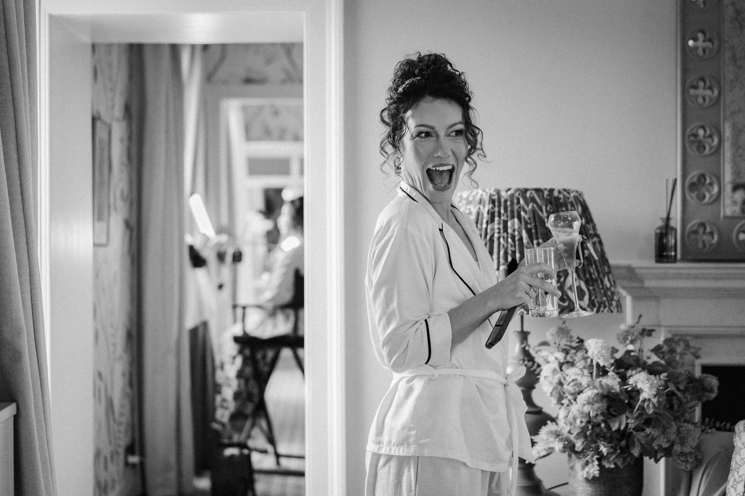 A series of black and white wedding photographs showing candid moments during the ceremony and preparation.
