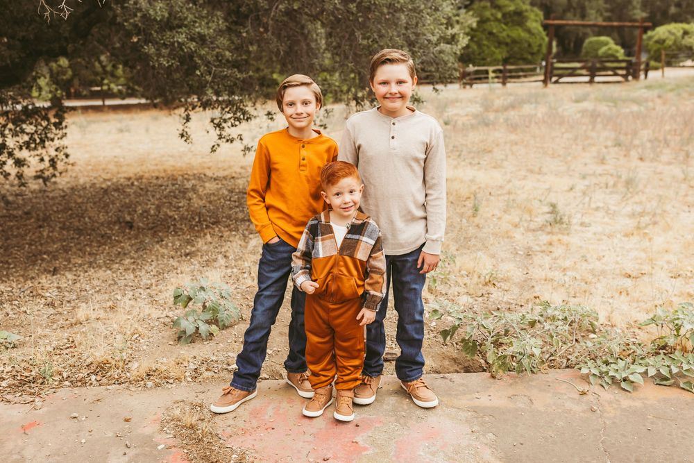 A group of candid outdoor family photos taken in a natural park setting with warm earth tones and casual clothing.