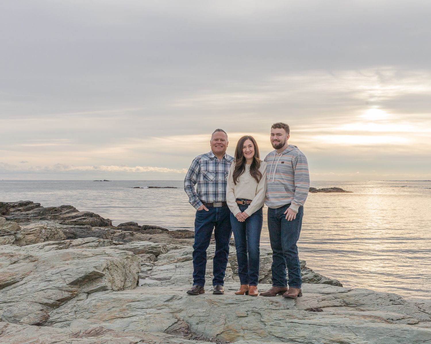 Family photo of 3 at sunset on the rocks on Brenton Reef in Newport, RI.