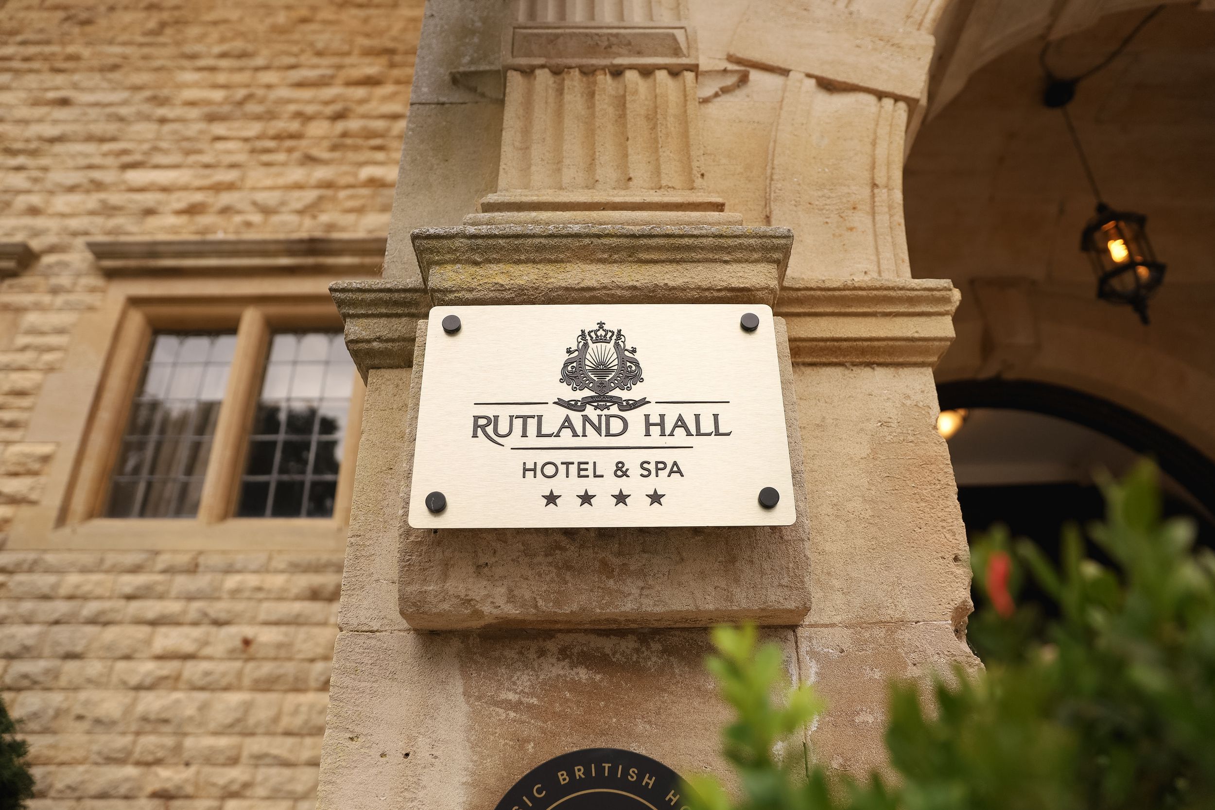 Close-up view of Rutland Hall Hotel signage and entrance columns on a sandstone building exterior.