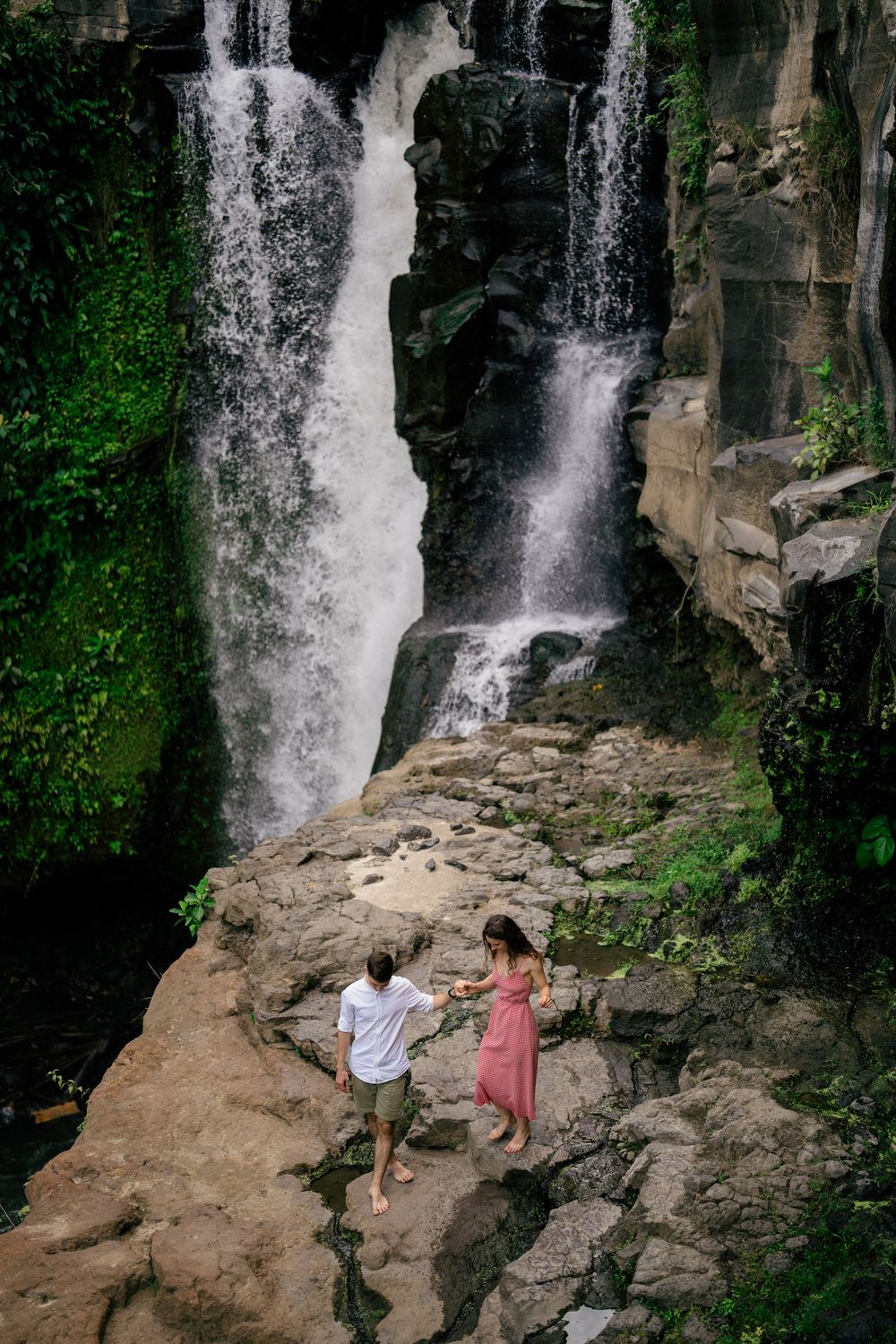 Couple engagement photography with Bali’s iconic Tegenungan Waterfall as the backdrop.